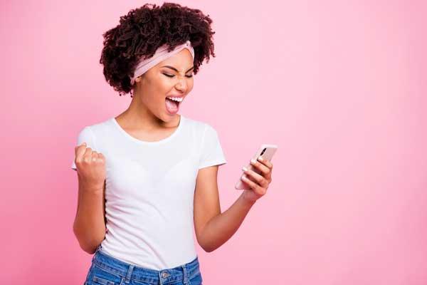 Happy MÜV Subscriber looking at their phone with a smile